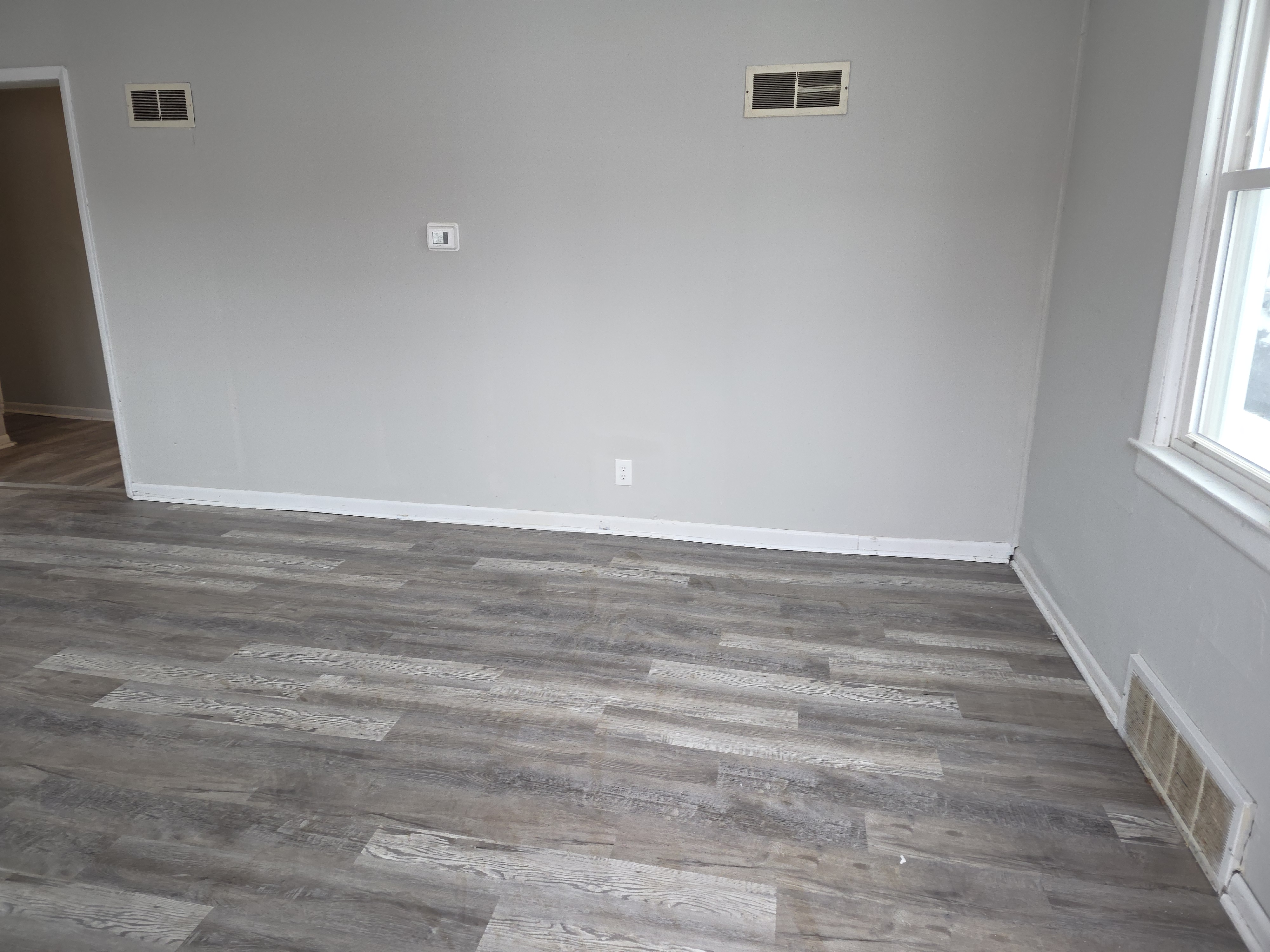 Living room after full turnover — new floor and paint