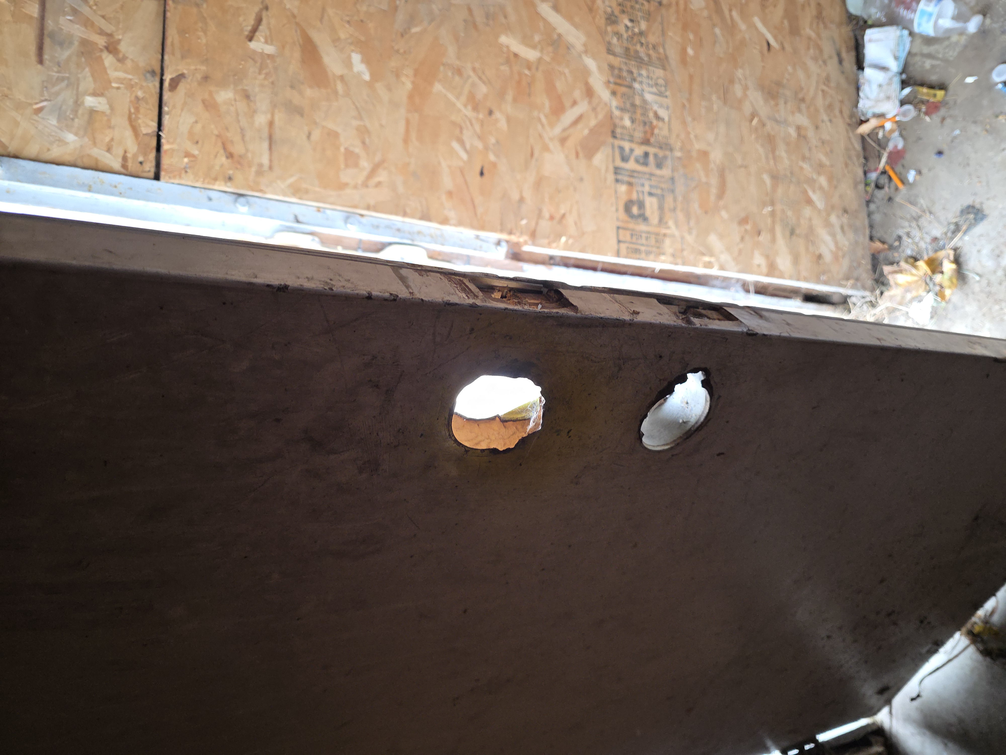 Door with damaged lock holes before repair
