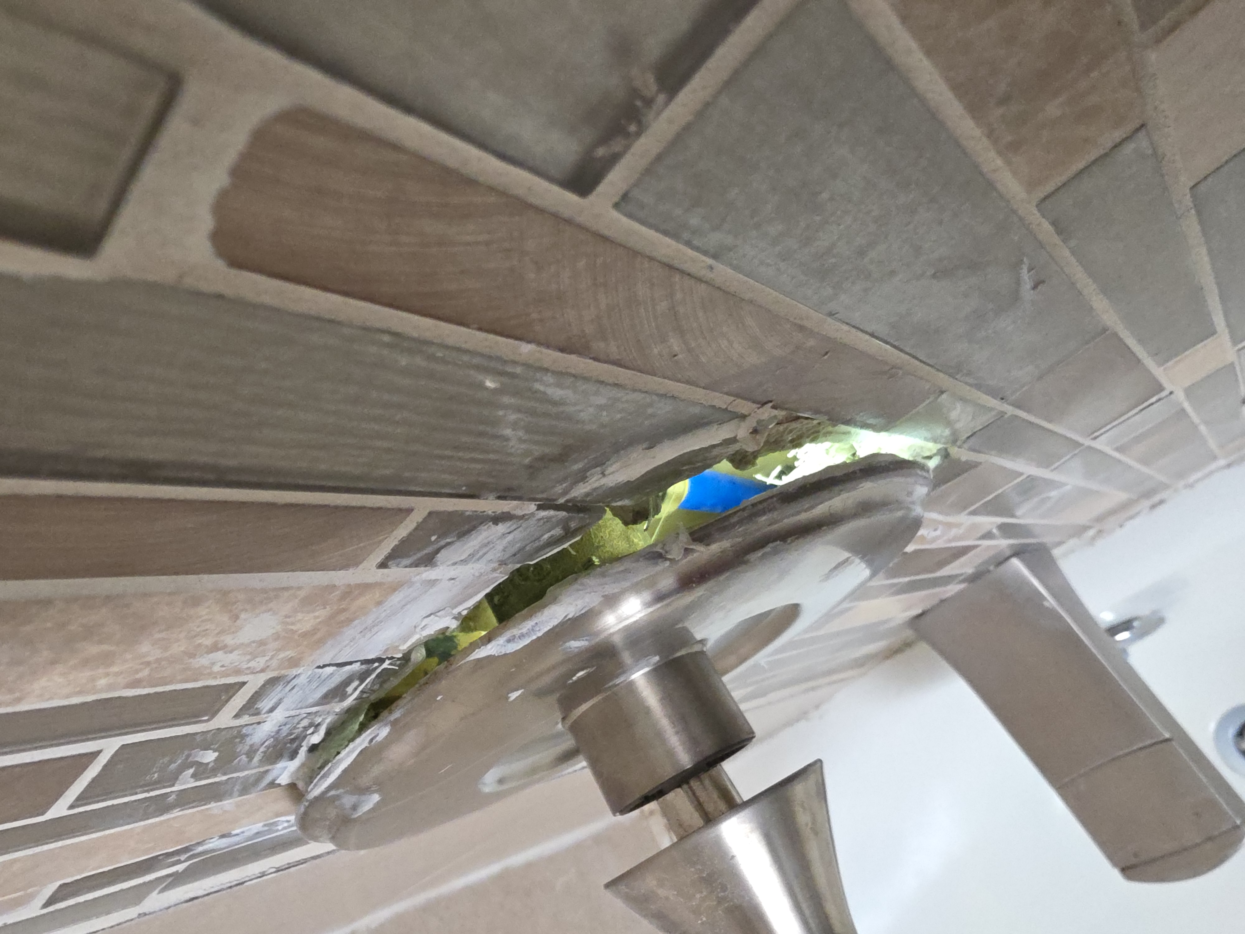 Shower handle pulling away from tile wall before repair