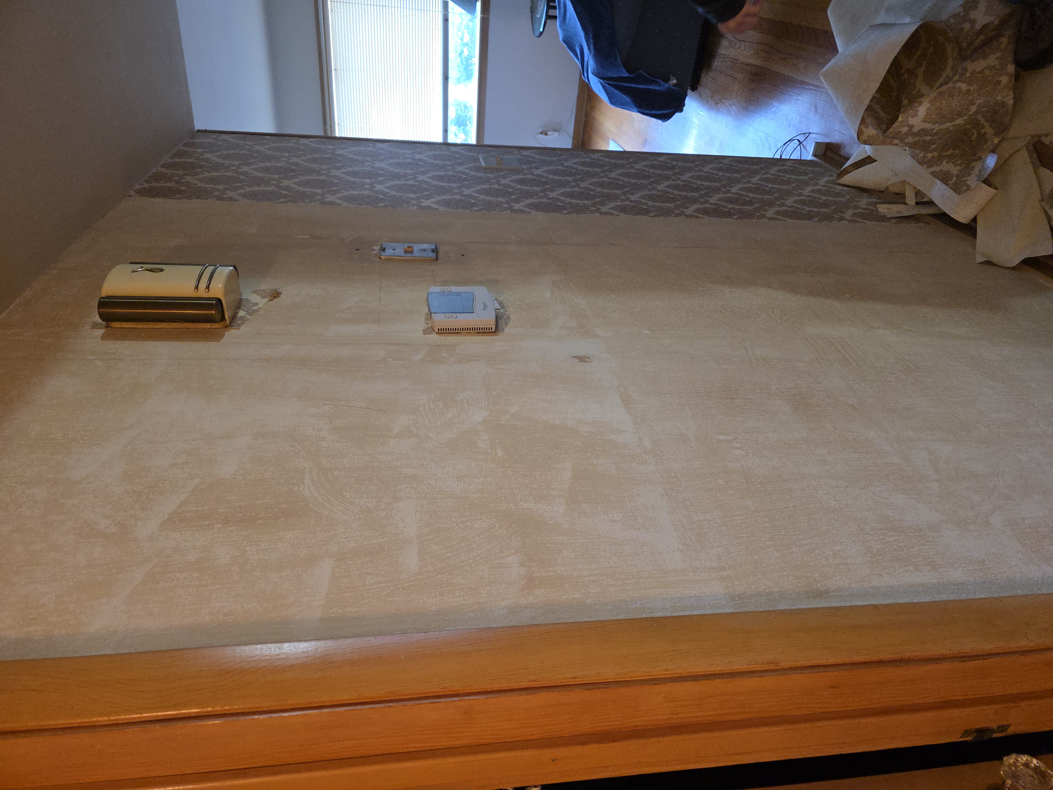 Wall with old wallpaper being stripped before